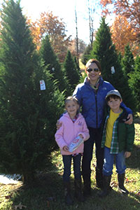 A happy family poses in the orchard of cut-your-own fresh Christmas Trees at New Castle Farms in Forrest City, Arkansas.